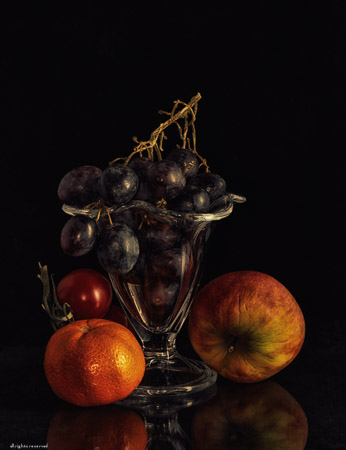 Grapes in ice coupe surrounded by other fruits