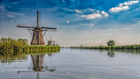 Row of dutch windmills alongside the canal   